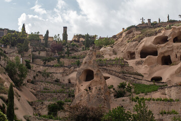 Cappadocia’s rock formations in Uçhisar, Turkey, display ancient cave dwellings carved into...