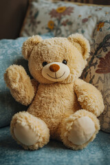 Fototapeta premium A teddy bear sitting on a couch with a pillow