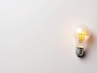 White background, light bulb on the right side of the image, top view, soft yellow glow inside it, high-resolution photography, high-quality photo