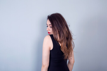 Fototapeta premium Studio portrait of beautiful young woman with long brunette hair