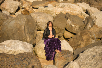 woman sitting on rock