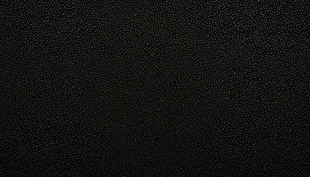 A black and white image features a textured, black background with a repeating pattern of small, evenly spaced dots, creating a minimalist, abstract design