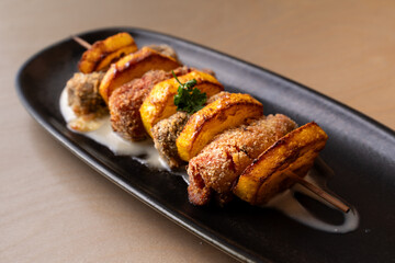 Gourmet Italian skewer with crispy breaded meat and pumpkin