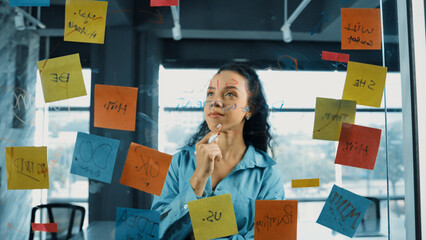 Portrait of skilled young beautiful hispanic project manager thinking about marketing idea....