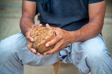 Man preparing fresh coconut water by cutting a coconut in Thailand