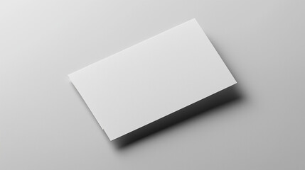 Blank white card on a flat surface, symbolizing simplicity and clarity in design.