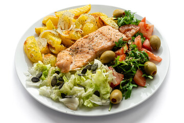 Baked red fish with vegetables and potatoes. Healthy food.