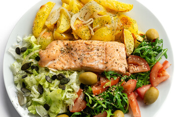 Baked red fish with vegetables and potatoes. Healthy food.