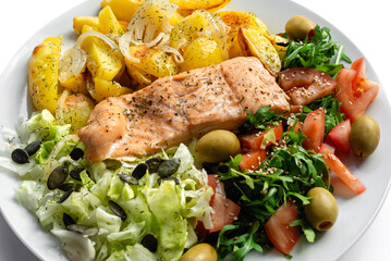 Baked red fish with vegetables and potatoes. Healthy food.