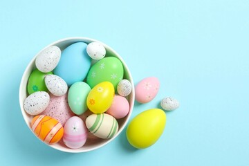 Happy Easter. Colorful eggs in a bowl on color background, space for text or advertising