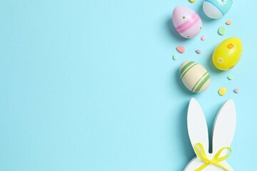 Happy Easter. Colorful eggs with bunny ears on color background, space for text or advertising