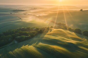 Aerial view of beautiful foggy sunrise over fields in the countryside