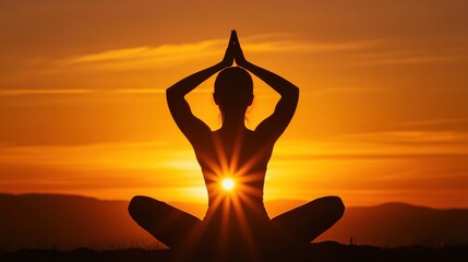 Woman Practicing Yoga on Mountaintop at Sunrise in Silhouette