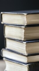 Fototapeta premium Stack of old books on table, dark background, education concept, website banner