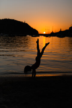 Silhouette of Child Playing at Sunset by Tranquil Beach in Soller