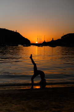 Sunset silhouette of a child near serene sea in Soller, Majorca