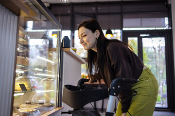 Woman with cerebral palsy with Walker Looking at Pastries