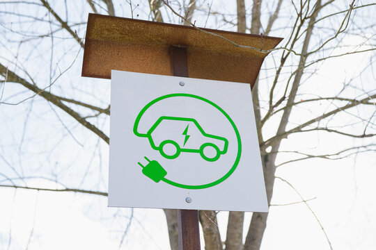 Electric car charging station sign in natural setting