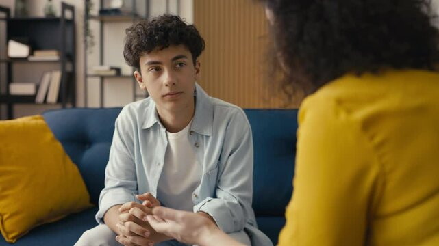 Displeased mother disciplining her teen son for bad behavior, misunderstanding