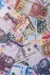 A background consisting of paper banknotes of different currencies