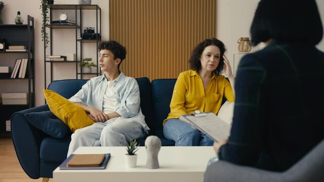 Upset mom complaining to a teen counselor about her adolescent son's behavior