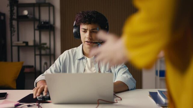Angry mom scolding her teen son for playing a video game instead of studying