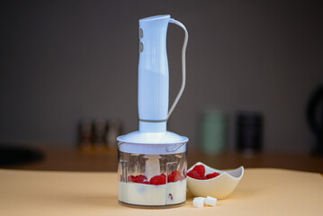 Blender with yogurt and berries, concept of diet and healthy food