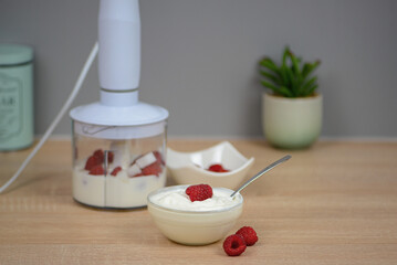 Blender with yogurt and berries, concept of diet and healthy food