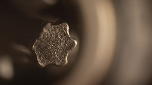Macro image of a rotating Torx bit on a power screwdriver. Close-up of a special screw tip used for furniture assembly