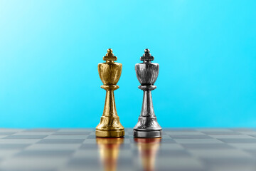 Golden and silver chess kings in middle of chessboard. Competition concept