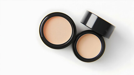 Open Compact Powder Cases Displayed On White Surface Showing Beige Powder With Black Trim Accessories