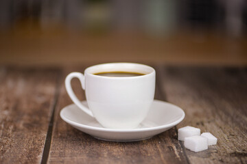 Fresh aromatic coffee on a wooden kitchen table