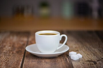 Fresh aromatic coffee on a wooden kitchen table