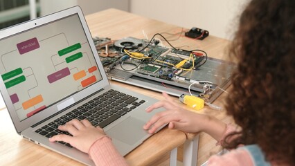 Back view of american girl coding engineering prompt while laptop screen display programing...
