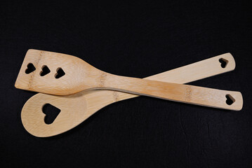 Bamboo Cooking Spoons with Heart Cutouts on a Black Background