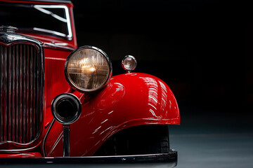 Fototapeta premium A glossy red vintage car stands