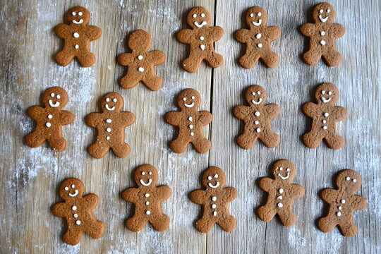 Gingerbread Cookie Gathering: A delightful array of gingerbread cookies, baked to perfection and arranged on a rustic wooden surface, evokes the warm, sweet nostalgia of the holiday season.