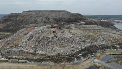 Work on unloading, systematising, debunking waste at the city's huge municipal waste collection...