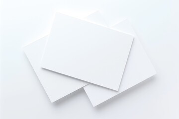 Three white business cards stacked on a clean background, providing ample space for text or branding. Ideal for mockups, corporate identity, and design presentations
