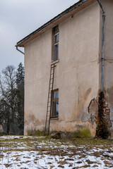 Mystical Forgotten Home with a Ladder Leading to a Broken Window