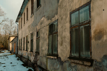Abandoned Building with Weathered Walls and Broken Windows