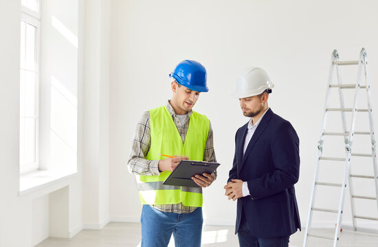 Builder and a businessman are planning construction or renovation of a home or office, reviewing an estimate. Conversation and collaboration with the architect to ensure the project success.