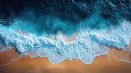 Fototapeta premium Aerial view of crashing waves on beach