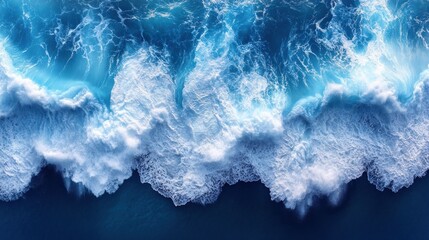 Fototapeta premium Aerial view of crashing waves on ocean