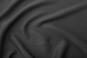 Elegant dark grey fabric texture with soft flowing folds and creases