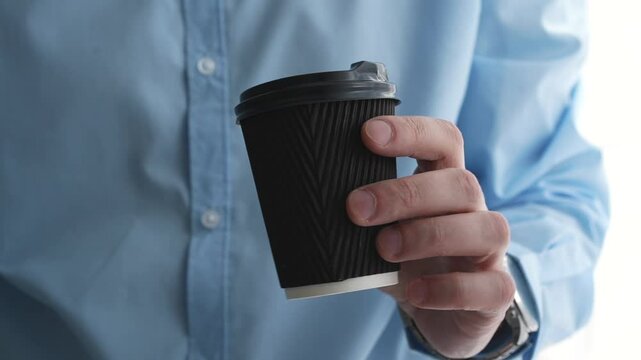 Close-up of a glass of coffee in the hands of an office worker.
Man with a cup of hot coffee.
Hot coffee in hands.
A man holds a glass of coffee.
Coffee, drink, americano, cappuccino, office