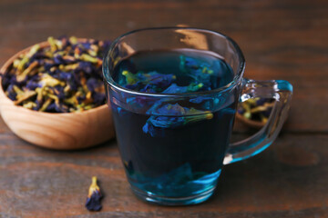 Delicious butterfly pea flower tea on wooden table