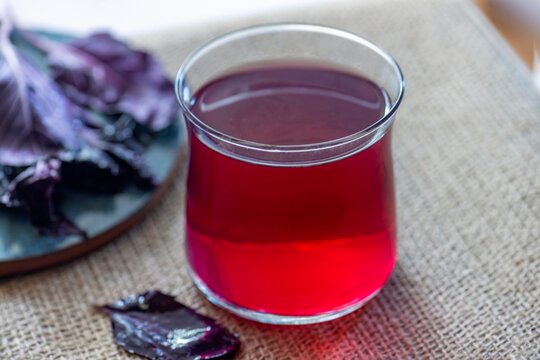 A  glass of purple basil cold drink called reyhan şerbet, a traditional Turkish beverage