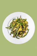 Freshly Prepared Wild Asparagus Omelette on White Plate With Green Background