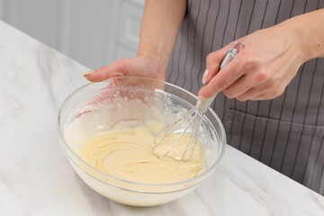 Woman making dough at white marble table indoors, closeup
